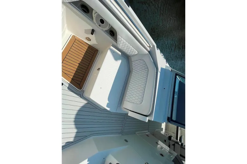 Slide: The Image of 2021 World Cat 400 DC-X boat interior with cushioned seating and teak flooring. - 34