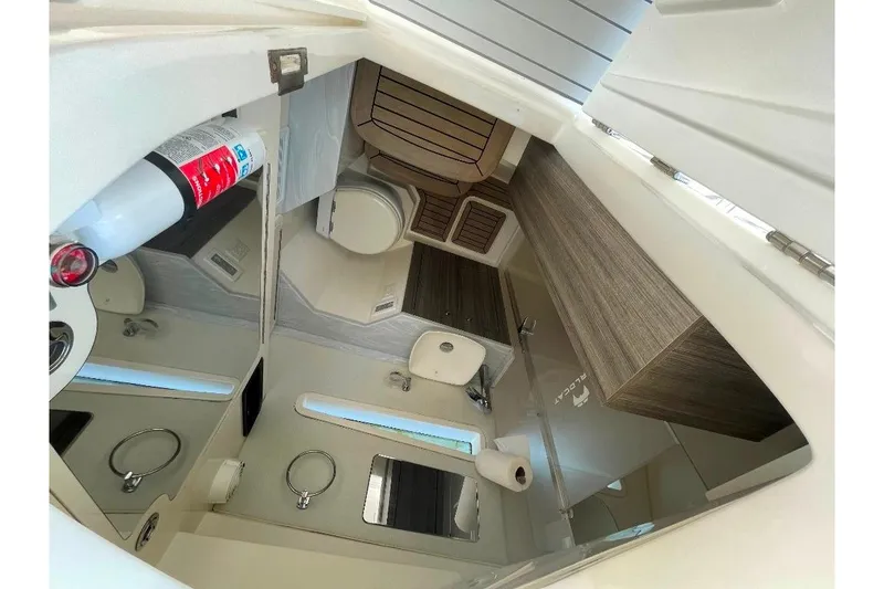 Slide: The Image of Interior of 2021 World Cat 400 DC-X boat, featuring a compact bathroom with modern amenities. - 35