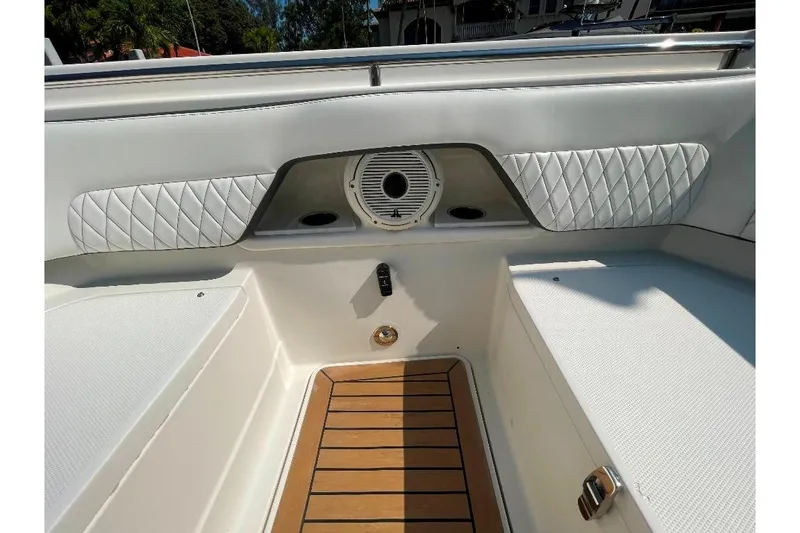 Slide: The Image of Interior view of 2021 World Cat 400 DC-X boat with cushioned seating and wood flooring. - 39