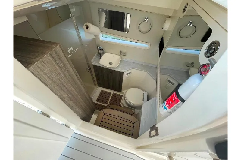 Slide: The Image of 2021 World Cat 400 DC-X boat bathroom with sink, toilet, and fire extinguisher. - 41