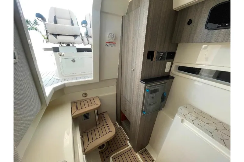 Slide: The Image of Interior of 2021 World Cat 400 DC-X boat, featuring modern seating and cabinetry. - 43