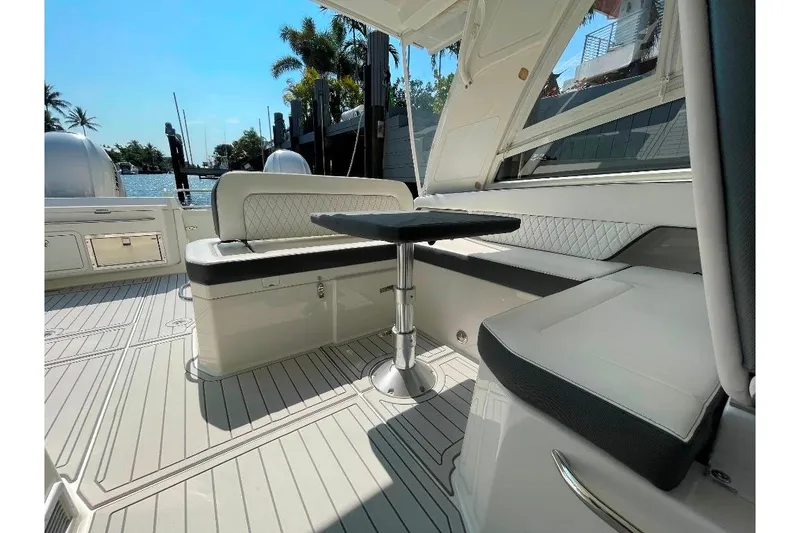 Slide: The Image of Luxurious seating area on 2021 World Cat 400 DC-X boat, featuring elegant upholstery and table. - 44