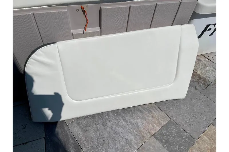 Slide: The Image of White cushion from a 2021 World Cat 400 DC-X boat on a tiled surface. - 48