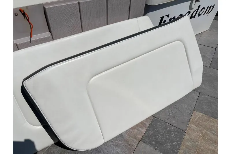 Slide: The Image of White cushioned seat from 2021 World Cat 400 DC-X boat on tiled surface. - 49