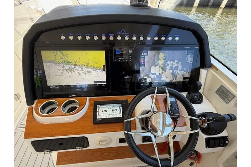 Slide: The Image of Dashboard of 2021 World Cat 400 DC-X boat with navigation screens and controls. - 5