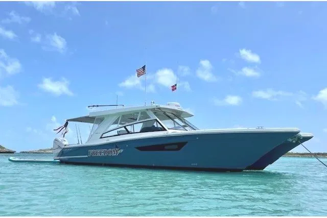Slide: The Image of World Cat 400 DC-X 2021 boat on clear water under blue sky. - 54