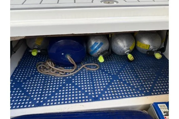 Slide: The Image of Storage compartment on a 2021 World Cat 400 DC-X with scuba tanks and rope. - 59