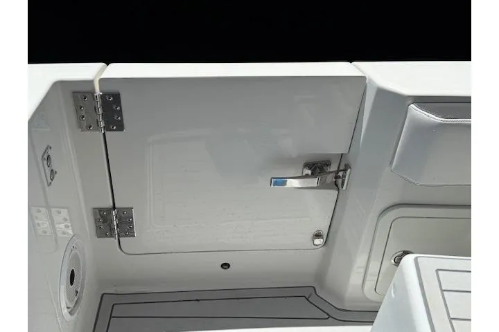 Slide: The Image of 2021 World Cat 400 DC-X boat interior, featuring a sleek white compartment with a metal latch. - 62