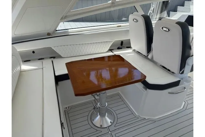 Slide: The Image of 2021 World Cat 400 DC-X interior with seating and wooden table. - 65