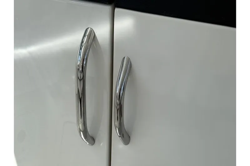 Slide: The Image of Chrome handles on a white cabinet door, World Cat 400 DC-X, 2021 model. - 9