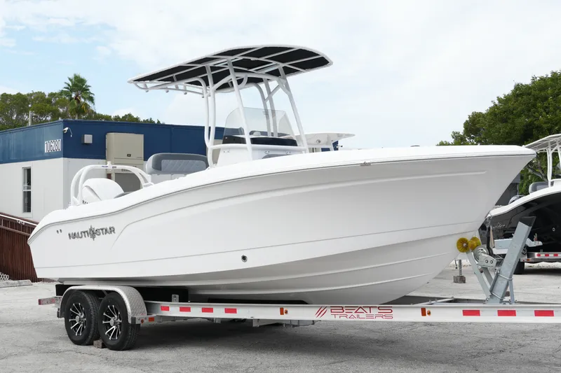 The Image of 2025 NauticStar 222 Offshore boat on trailer, displayed outdoors. - 0