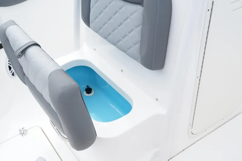 Slide: The Image of 2025 NauticStar 222 Offshore boat seating with integrated storage compartment. - 10