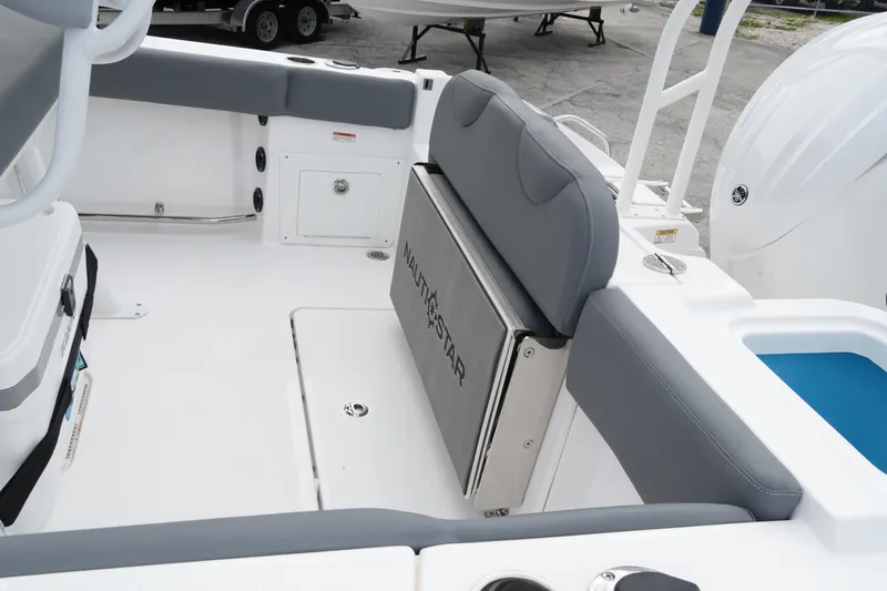 Slide: The Image of 2025 NauticStar 222 Offshore boat interior with gray seating and storage compartments. - 14