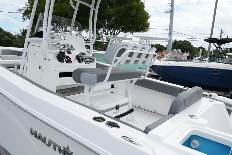 Slide: The Image of 2025 NauticStar 222 Offshore boat interior with seating and control panel. - 15