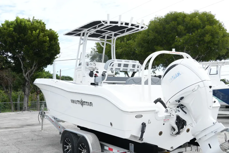 Slide: The Image of 2025 NauticStar 222 Offshore boat on trailer, featuring Yamaha outboard motor. - 2