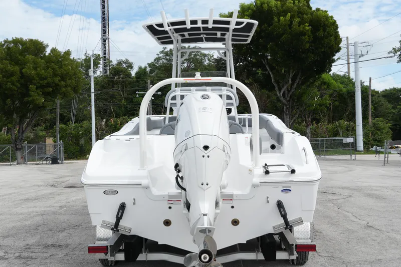Slide: The Image of 2025 NauticStar 222 Offshore boat, rear view with outboard motor, parked on trailer. - 3