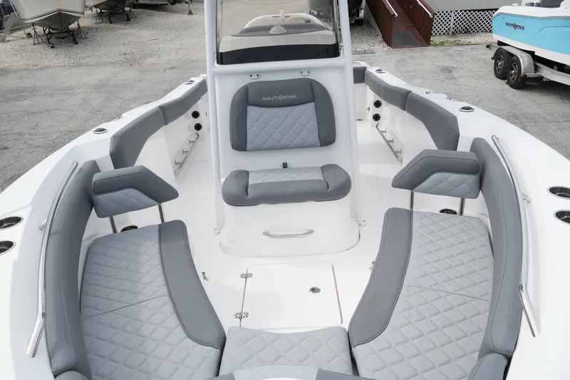 Slide: The Image of 2025 NauticStar 222 Offshore boat interior with gray seating and spacious layout. - 7