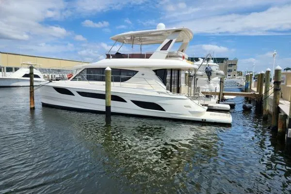 The Image of Luxury 2014 Aquila 48 PC yacht docked at marina under blue sky. - 1