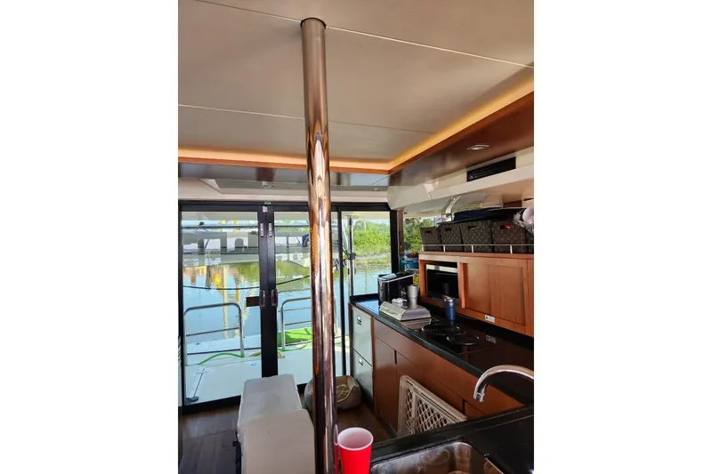 Slide: The Image of Interior of 2014 Aquila 48 PC yacht with modern kitchen and scenic view. - 10