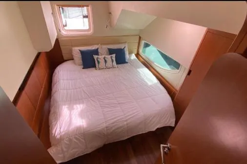Slide: The Image of Cozy bedroom in 2014 Aquila 48 PC yacht with large bed and nautical decor. - 12