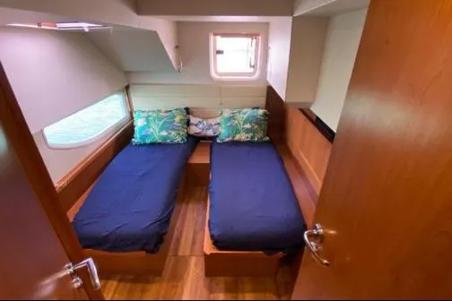 Slide: The Image of Interior cabin of 2014 Aquila 48 PC yacht with twin beds and tropical-themed pillows. - 14
