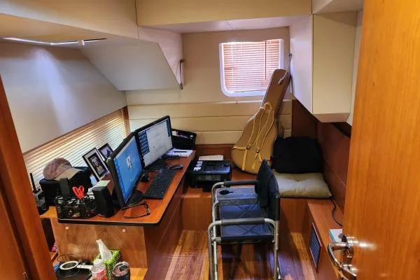 Slide: The Image of Office space inside 2014 Aquila 48 PC yacht with desk, monitors, and guitar case. - 16