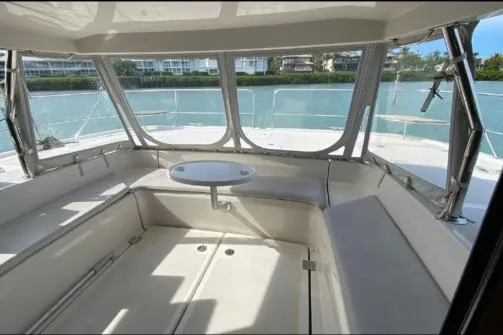 Slide: The Image of 2014 Aquila 48 PC yacht interior with seating and table, overlooking serene water. - 18