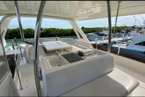 Slide: The Image of Luxurious 2014 Aquila 48 PC yacht interior with spacious seating and scenic marina view. - 19