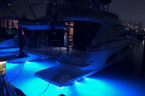 Slide: The Image of Aquila 48 PC 2014 yacht with blue underwater lights at night. - 23