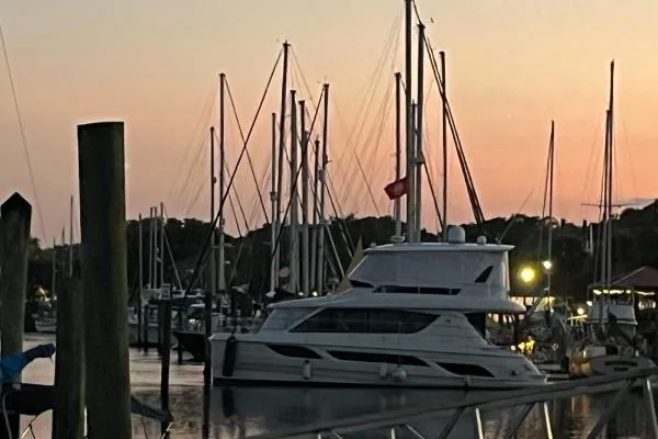 Slide: The Image of Aquila 48 PC 2014 yacht docked at sunset in a serene marina. - 25