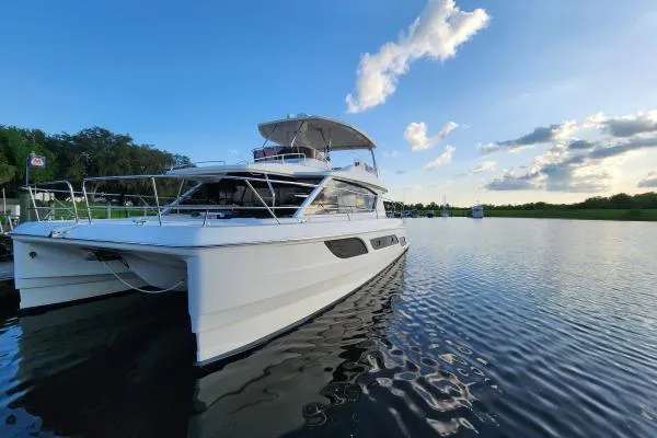 Slide: The Image of Aquila 48 PC 2014 yacht on serene water under a blue sky. - 5