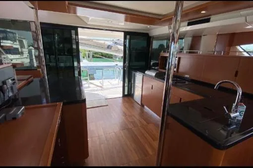 Slide: The Image of Interior of 2014 Aquila 48 PC yacht with modern kitchen and sleek wood finishes. - 9