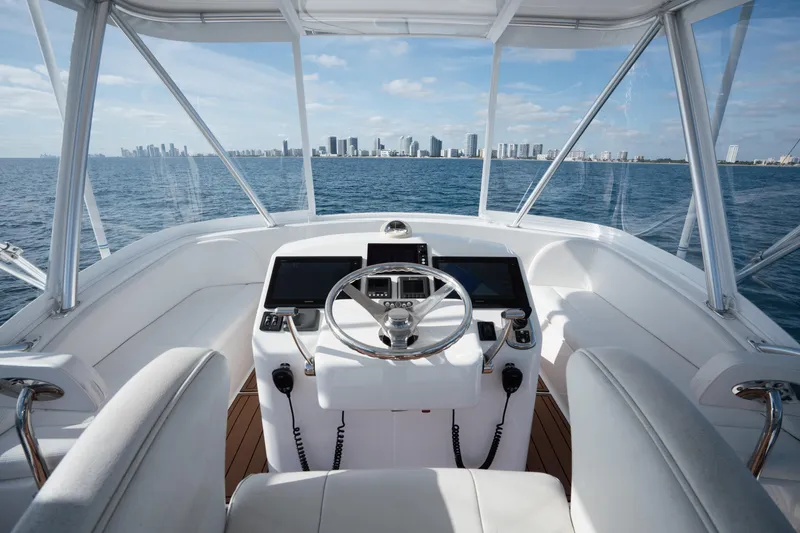Slide: The Image of Helm of 2018 Viking 37 Billfish yacht with city skyline view. - 12