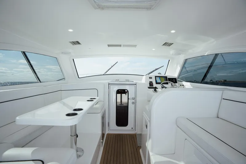 Slide: The Image of Interior of 2018 Viking 37 Billfish yacht, featuring sleek white seating and modern controls. - 16