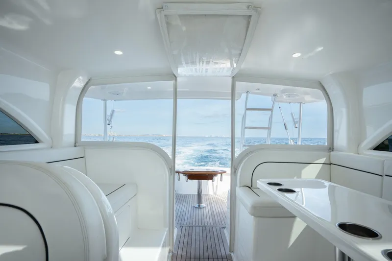 Slide: The Image of Interior view of 2018 Viking 37 Billfish yacht, featuring sleek seating and ocean backdrop. - 18