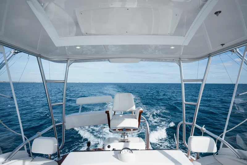Slide: The Image of 2018 Viking 37 Billfish yacht cruising on open ocean, view from helm. - 2