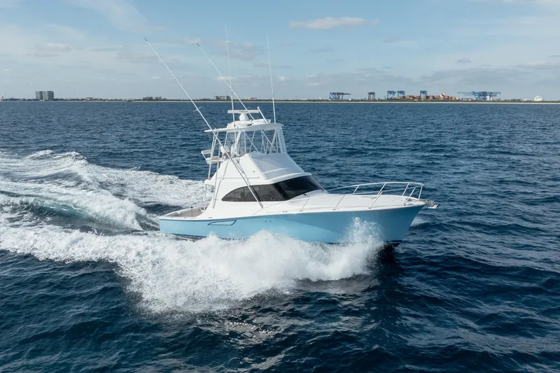 Slide: The Image of 2018 Viking 37 Billfish yacht cruising on open water, creating waves. - 28