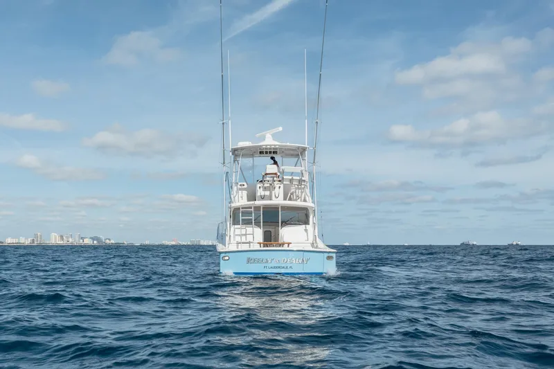 Slide: The Image of 2018 Viking 37 Billfish yacht on open sea with city skyline in background. - 38