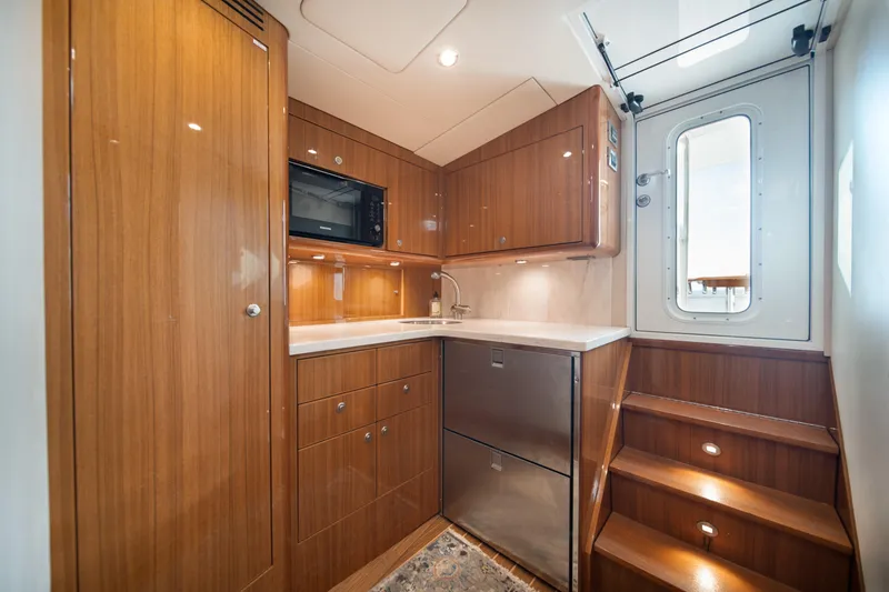 Slide: The Image of Luxurious 2018 Viking 37 Billfish yacht interior with modern kitchen and wooden cabinetry. - 4