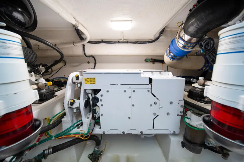 Slide: The Image of Engine room of 2018 Viking 37 Billfish boat, showcasing mechanical components and wiring. - 42