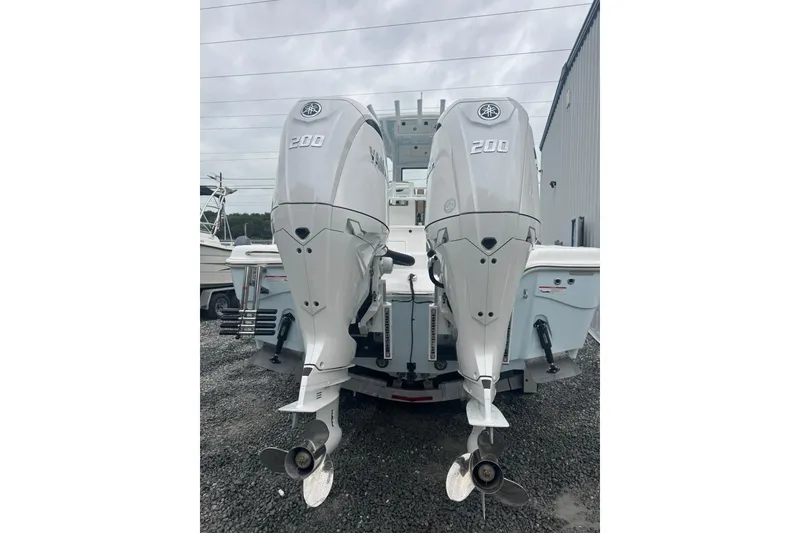 Slide: The Image of 2026 Blazer Bay Makaira 2800 boat with dual engines and seating, American flag in background. - 13