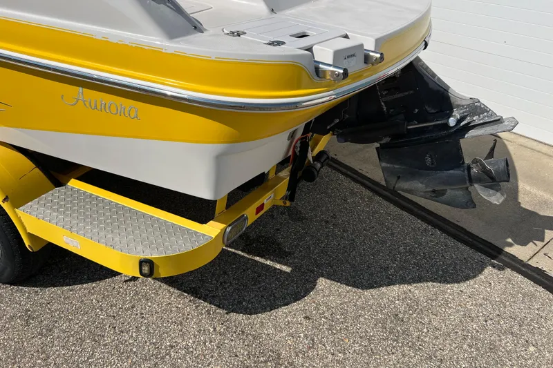 Slide: The Image of Yellow 2004 Starcraft Aurora 2000 I/O boat rear view with propeller and trailer. - 18