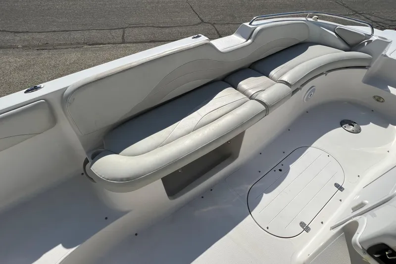 Slide: The Image of 2004 Starcraft Aurora 2000 I/O boat interior with white seating and storage compartment. - 19