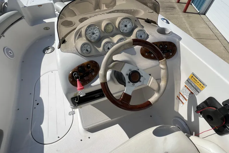 Slide: The Image of 2004 Starcraft Aurora 2000 I/O boat dashboard with steering wheel and gauges. - 2