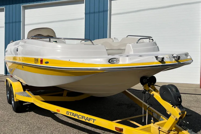 Slide: The Image of 2004 Starcraft Aurora 2000 I/O boat on yellow trailer, parked outdoors. - 4