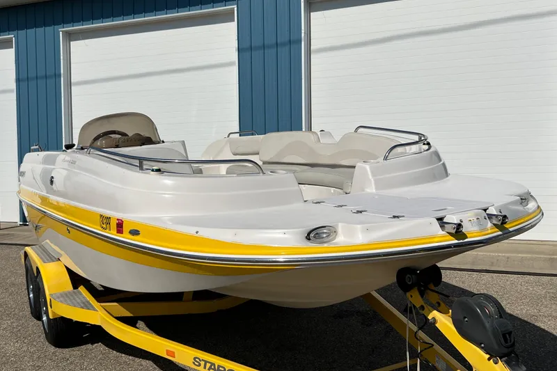 Slide: The Image of 2004 Starcraft Aurora 2000 I/O boat on yellow trailer, parked outdoors. - 7