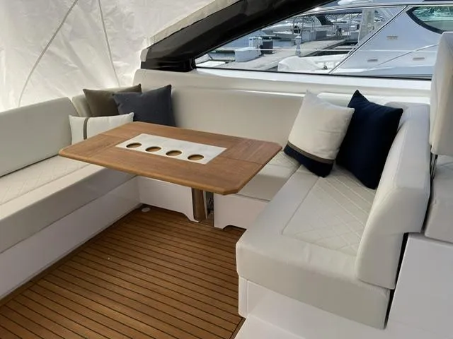 Slide: The Image of Luxurious seating area on 2020 Fairline 45/43 Targa yacht with wooden table and cushions. - 10