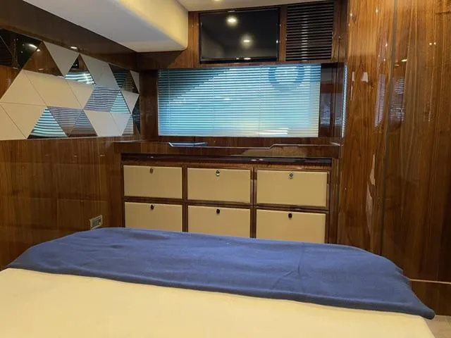 Slide: The Image of Interior of 2020 Fairline 45/43 Targa yacht, featuring wood paneling and modern cabinetry. - 14