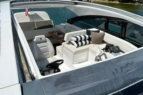 Slide: The Image of 2020 Fairline 45/43 Targa yacht interior with seating and table, docked on water. - 4