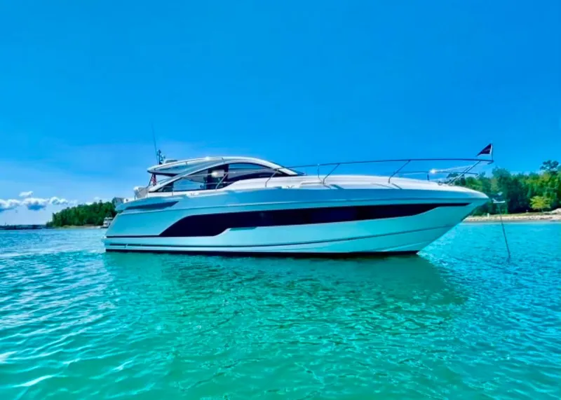 Slide: The Image of 2020 Fairline 45/43 Targa yacht on clear turquoise water under a bright blue sky. - 6